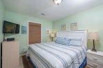 Guest room with comfortable king bed and twin bunk, smart tv.